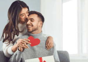 cards for valentine's day woman gives man a kiss on the forehead and a cutout heart